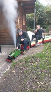 Young person riding a model train